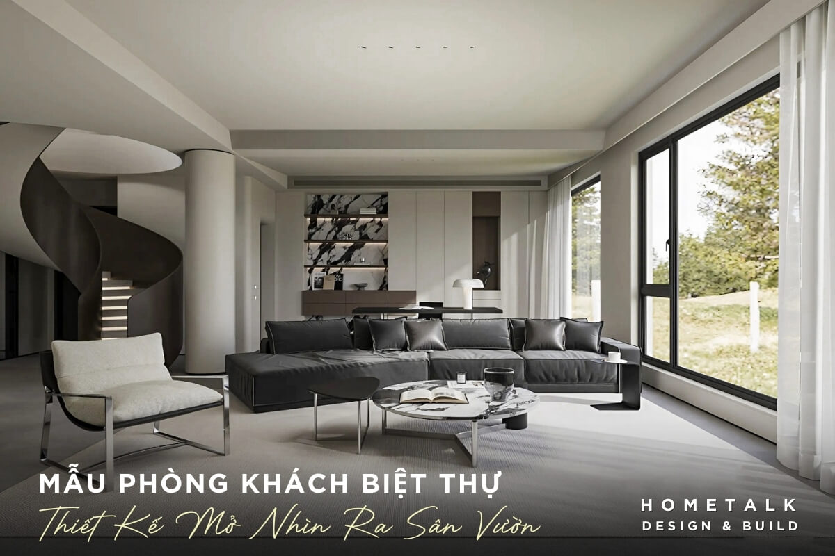 noi that phong khach voi bo sofa lon mau xam den va thiet ke buc tuong kinh lon, giup tan dung toi da anh sang tu nhien va tao su ket noi voi khong gian ben ngoai